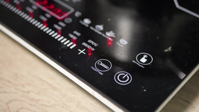 Black Glossy Induction Cooktop Turning on in Modern Kitchen with Electronic Beep Sound and Fan Whirring Noise Technology Home Appliance Efficiency Concept Detailed Close up Visual