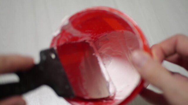 Finish Plaster Being Mixed in Red Bucket with Metal Spatula Close up View Thick Squishing and Scraping Sound Effects Construction DIY Renovation Home Improvement Concepts Detailed Material Texture
