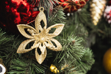 Christmas tree with golden ball as snowflake and lights garland. Xmas card. Close up. Winter. Outdoors.
