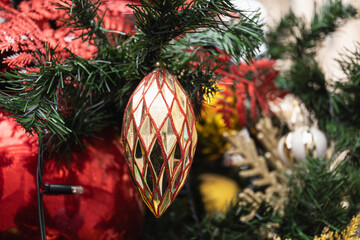 Christmas tree with red ball and lights garland. Xmas card. Close up. Winter. Outdoors.