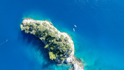 Stunning overhead view of rugged cliffs and crystal-clear Mediterranean water.