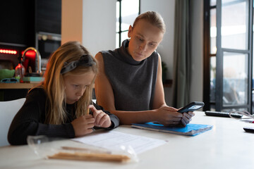 Mother assisting child with school homework