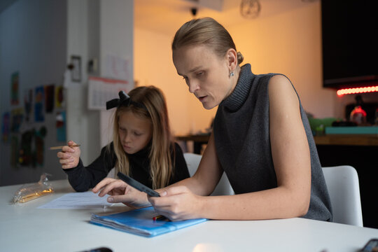 Mother helping daughter with homework