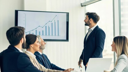 Business presenter pointing rising bar chart during diverse team meeting modern office business presentation with presenter showing growth chart - Powered by Adobe