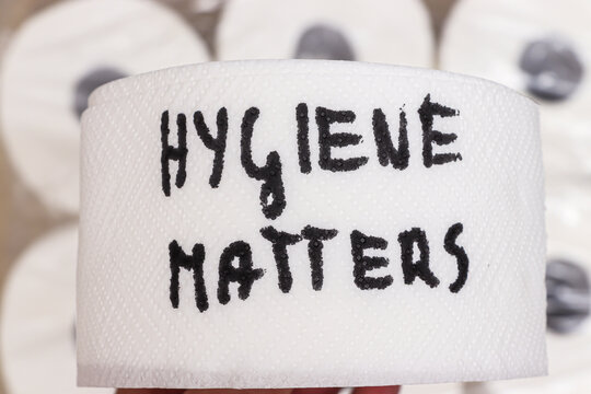 Handwritten message on a roll of toilet paper conveys the importance of hygiene. This paper emphasizes cleanliness, suitable for health campaigns and personal care discussions.