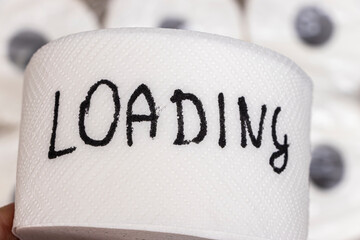 Close-up of a roll of toilet paper with the word LOADING written in bold black letters. Ideal for themes of humor, everyday life, or expectations in various contexts.