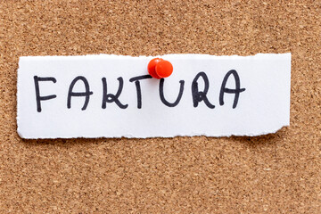 A handwritten note displaying the word FACTURA pinned on a corkboard background. This document is commonly associated with invoicing and accounting processes, highlighting financial obligations.