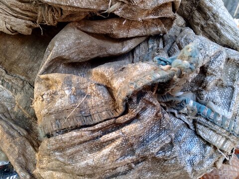 Weathered Textile Texture: An intimate view of a rough textile fabric, revealing the subtle imperfections and time-worn character of the material's surface.