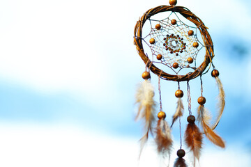 Shamanism. Beautiful dream catcher hanging outdoors, low angle view. Space for text