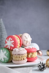 Tasty Christmas macarons on white table, closeup. Space for text