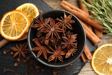 Different spices, dry orange slices and fresh rosemary for mulled wine on table, flat lay
