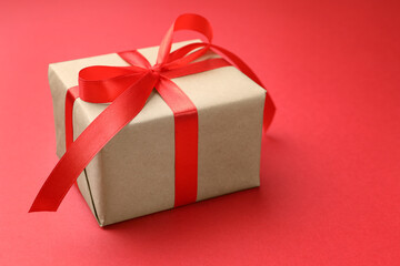 Beautiful gift box on red background, closeup
