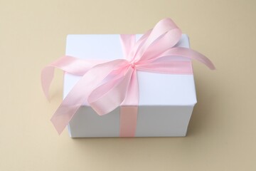 Beautiful gift box on beige background, closeup