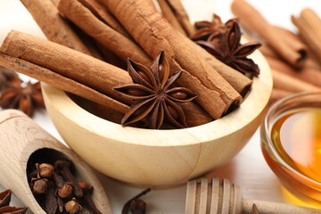 Different spices and honey for mulled wine on white table, closeup