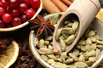 Different spices and cranberries for mulled wine on table, closeup