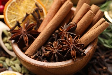 Different spices and dry orange slices for mulled wine on table, closeup