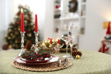 Festive table setting with Christmas decor and burning candles indoors, closeup