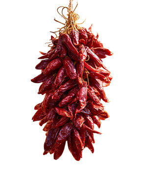 Close up of hanging dried red chili ristra with deep red wrinkled peppers.