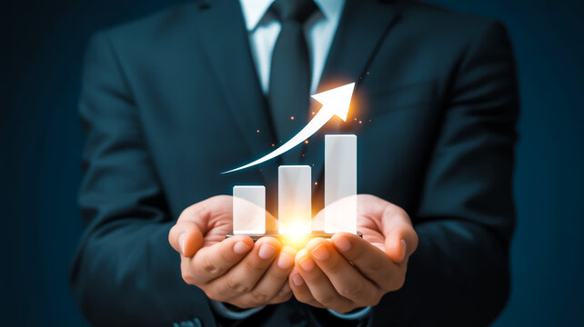 A professional business photograph of hands holding a glowing 3D white bar graph with an upward arrow against a dark teal backgroun