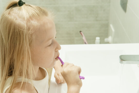 Man in a white baseball cap looking intently at his smartphone outdoors, concept of digital communication, mobile technology, or online social networking.