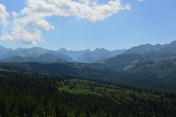 Fototapeta premium High Tatras seen from a metal observation tower with a modern glass terrace offering a stunning panorama at Poronin, Poland. Majestic mountains peaks of High Tatra moutnains.