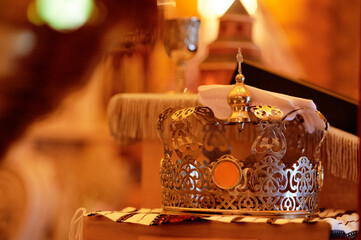 Ornate Orthodox Wedding Crowns in a Church Setting With Religious Symbols
