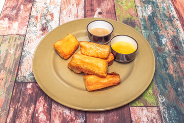 Crispy fried yuca with habanero and mango salsa, perfect for sharing as an appetizer or main course