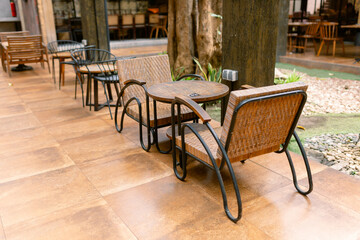 Inviting outdoor cafe seating with wicker chairs and wooden tables perfect for relaxing afternoons and casual conversations, creating a warm and welcoming atmosphere