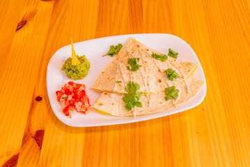 Barbacoa quesadillas with shredded lamb, red onion, and a sprinkle of Cotija cheese