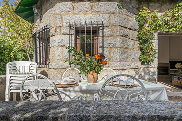 Rear facade with a polished gray granite porch and square pillars of the same material, integrating the outdoor pool through a uniform material language