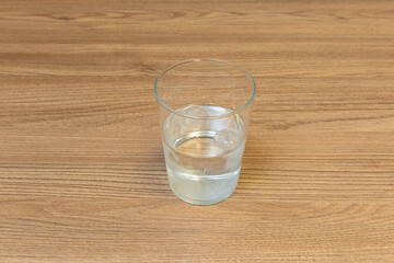 Condensation droplets slide down the vertical filigree of a chilled glass, magnifying the handcrafted detail of its surface