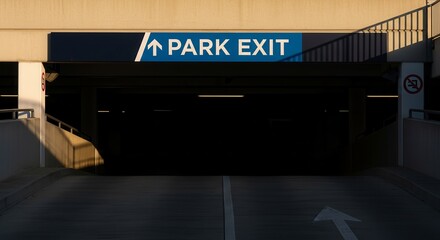 Park Exit Sign And Arrow In A Dark Parking Garage With Sunlight And Shadows