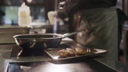 Close up shot of unrecognizable professional chef taking out fried duck breast meat on metal tray while cooking dishes in restaurant kitchen, copy space - Powered by Adobe