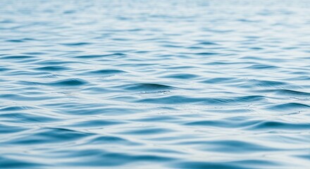 Naklejka premium Calm blue ocean water reflecting the sunlight creating a serene natural ripple background scene