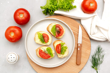 Bruschetta sandwich bread toast with cheese ricotta,tomatoes. healthy vegetarian food,Italian cuisine appetizer,basil greenery on cutting board. top view flat lay.