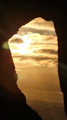 sunrise through a burned out hole in a tree