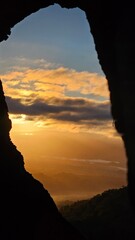 sunrise through a burned out hole in a tree