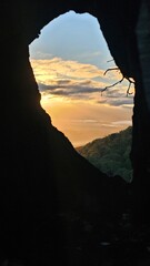 sunrise through a burned out hole in a tree