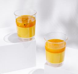 Refreshing layered juice served in clear cups on a white surface