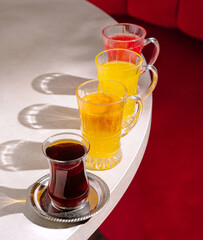 Colorful beverages on a table in a cozy cafe setting during afternoon