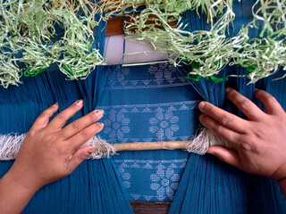 Handloom weaver in India working in her loom.
