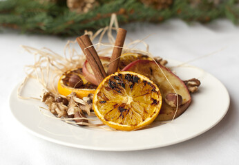 christmas decoration with cinnamon, orange and nuts