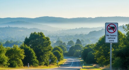 Scenic Mountain Countryside With a 'No Heavy Vehicles' Road Sign on Display