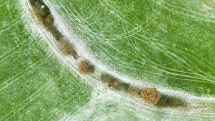 Curved Tractor Tracks Frost Covered Agricultural Field Aerial