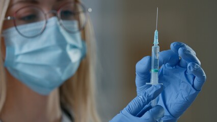 Close up Caucasian woman doctor in medical face mask holding syringe injection vaccination in clinic nurse female girl preparing for vaccine remedy covid19 medication medicine health care antivirus