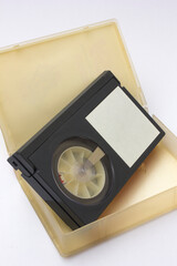 Vintage black vhs video cassette tapes with blank white labels, isolated on white background.