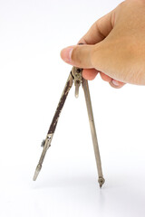 A close-up photo of an old compass, isolated on white background.