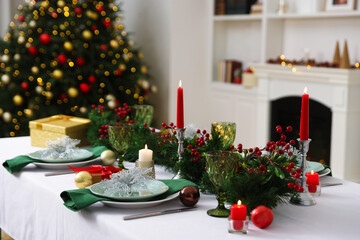 Festive table setting with Christmas decor and burning candles indoors, closeup