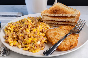 scramble eggs  mixed with  corn beef hash withhash browns