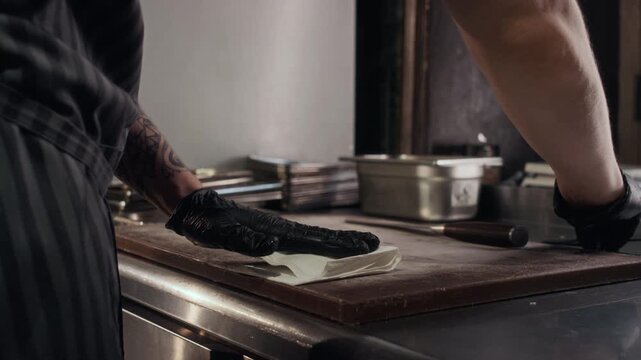 Close up shot of unrecognizable professional chef carefully drying scallop meat on paper towel preparing for cooking delicate seafood dish in restaurant kitchen, copy space